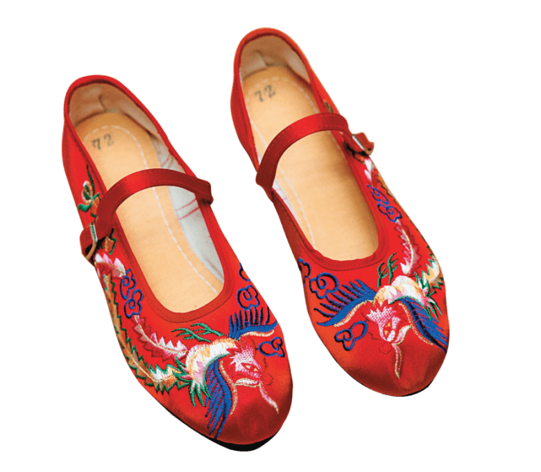 The red embroidered shoes represent luck are one of the best sellers in the shop.