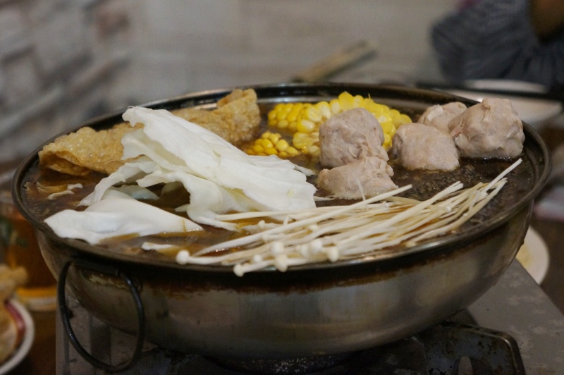 ginger duck hot pot with tofu skins, cabbage, and meatballs