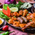 An assortment of fish, chicken and lamb kebabs on a platter, a signature dish from Muslim-owned restaurants. (Photo・Ali Baba's Indian Kitchen)