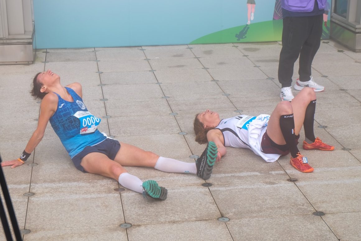 Valentina Belotti of Italy, left, and Verena Schmitz of Germany recover at the finish line of the first round.
