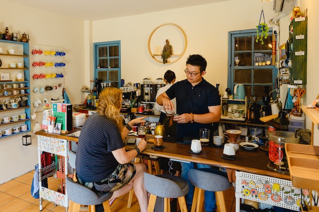 Vincent Bu talks to a visitor at his Chi Tao ceramics and coffee shop.
