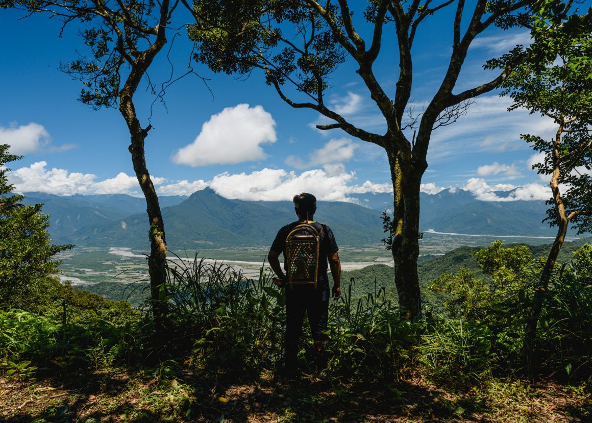 Xiao Ma overlooks the East Rift Valley from a lookout near the Gao Shan Forest Tribal Ranch, which he established to preserve his tribe's history and wisdom. He offers healing experiences in nature that harness the power of the forest.
